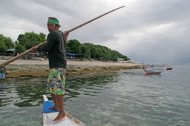 With the fishing boat over the reef